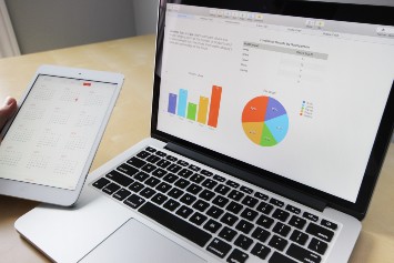Laptop displaying colorful graphs